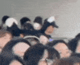 a crowd of people are sitting in a row on an airplane .