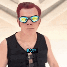 a man wearing sunglasses and a vest that says bass on it