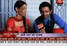 a man and a woman are being interviewed on tv