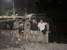 a group of young men are posing for a picture and one of them is wearing a nba shirt