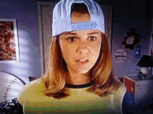 a woman is upside down and wearing a hat