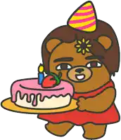 a teddy bear wearing a party hat is holding a cake with candles on it