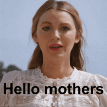 a woman in a white lace top says hello mothers in black letters