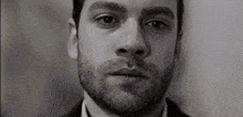 a close up of a man 's face with a tear running down his cheek