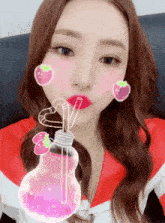 a girl with strawberries on her cheeks is drinking from a light bulb with a straw