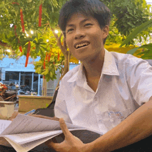 a young man wearing a white shirt with a sticker on it that says ' a ' on it