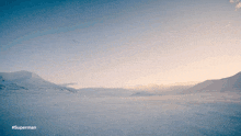 a snowy landscape with mountains in the background and #superman on the bottom