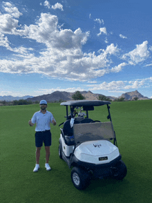 a man stands in front of a golf cart that says ezgo on the front