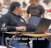 a man is sitting at a desk with a laptop and a skull on the desk .