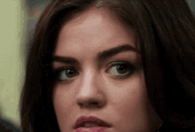 a close up of a woman 's face with a serious look on her face .