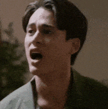 a close up of a man with his mouth open .