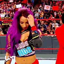 a woman with purple hair is wearing a shirt that says boss hug on it .