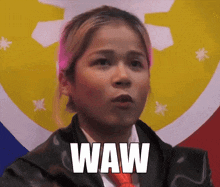 a woman wearing a black jacket and red tie says waw