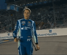 a man wearing a nascar cup series jacket talks to the camera