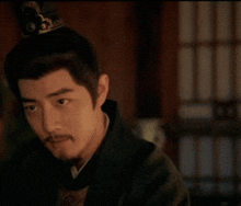 a man with a beard wearing a crown on his head