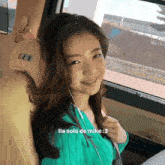 a woman in a green sweater is sitting in the back seat of a car with the caption lia solo de mike : 3