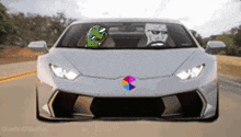 a white sports car with a sticker on the windshield that says pepe the frog
