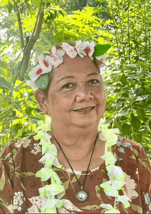 a woman wearing a lei and a flower crown on her head