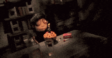 a cartoon character is lighting a candle on a birthday cake .