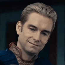 a close up of a man 's face with a slight smile