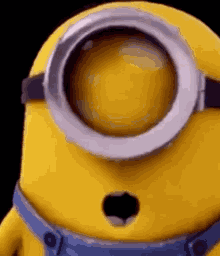 a close up of a minion with a surprised look on his face and a hole in his mouth .