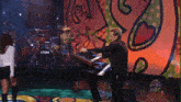 a man is playing a keyboard in front of a drum set that says tama