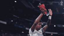 a soccer player wearing a number 20 jersey holds up a trophy