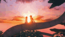 a boy and a girl are sitting on a tree branch looking at the sun