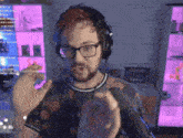 a man with glasses and headphones is talking into a microphone