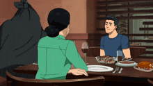 a man and a woman are sitting at a table with plates of food and a glass of wine