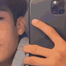 a close up of a person taking a selfie with their phone .