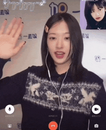 a girl wearing ear buds and a sweater is having a video call