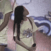 a woman wearing a white t-shirt that says " a world "