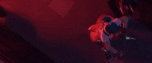 a person in a red glove is holding a sword in their hand .