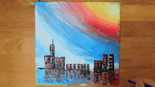 a person is painting a city skyline with a brush