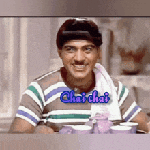 a man in a striped shirt has chai chai written on his chest