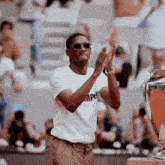 a man wearing sunglasses and a shirt that says mph