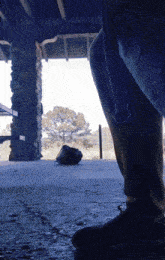 a person standing in front of a stone pillar