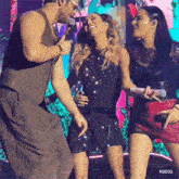 a man and two women laughing on a stage with rbd3d written on the bottom