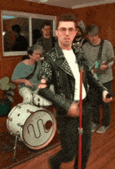 a man singing into a microphone in front of a drum that says sub-radio