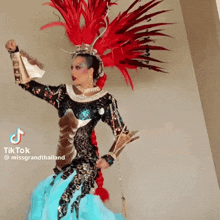 a tiktok video of a woman in a colorful costume with the caption missgrandthailand