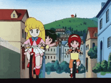 a group of girls are riding bikes down a street