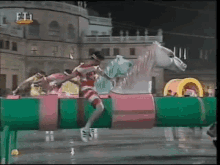 a person is jumping over a fence in front of a building that says et1 on it