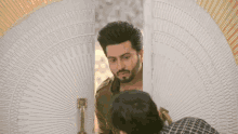 a man is looking at himself in a mirror