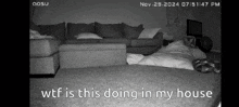 a black and white photo of a living room with the words wtf is this doing in my house at the bottom