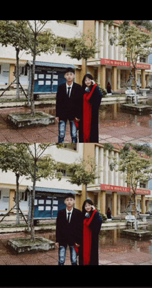 a man and a woman pose for a picture in front of a building that says ' a ' on it