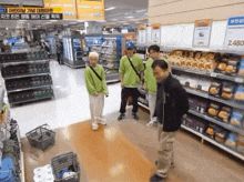 a group of people are standing in a store with a sign that says 2480