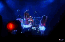a group of people are on a stage with a drum that says rbd on it