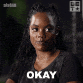 a woman in a black shirt says thank you in white letters