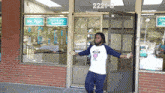 a man is standing in front of a store with a sign that says we print